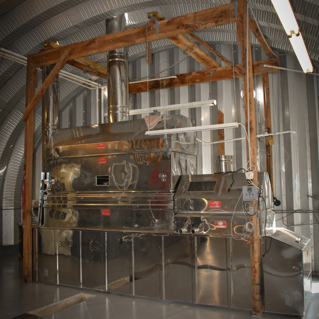 Large stainless steel maple syrup evaporator inside sugarhouse at Graves Maple Products in Pennsylvania, used for boiling sap into pure maple syrup.