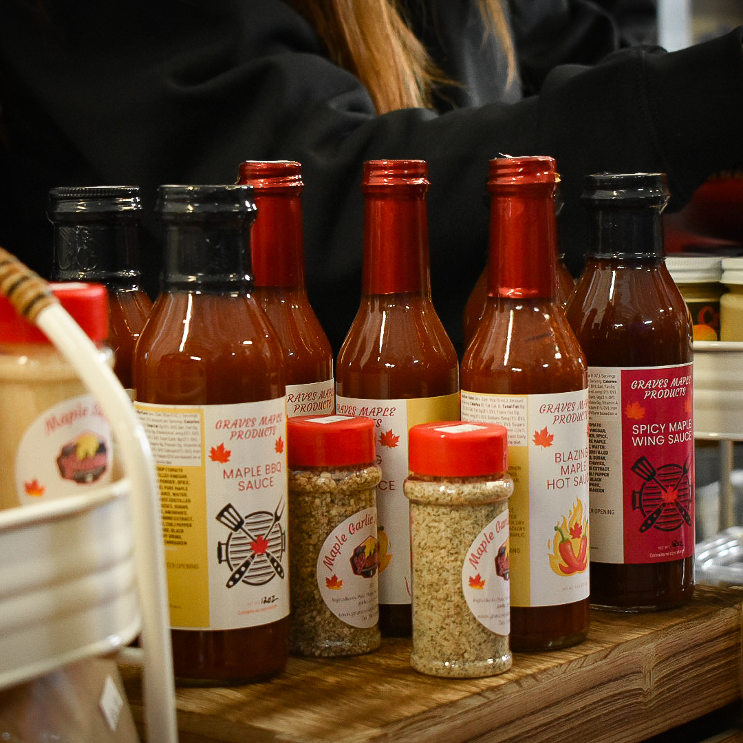 Product line of assorted Graves Maple Products including maple syrup and gourmet condiments, handcrafted in Pennsylvania.
