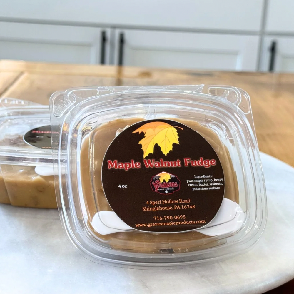 Maple Walnut Fudge in a container with a visible label on a marble surface.