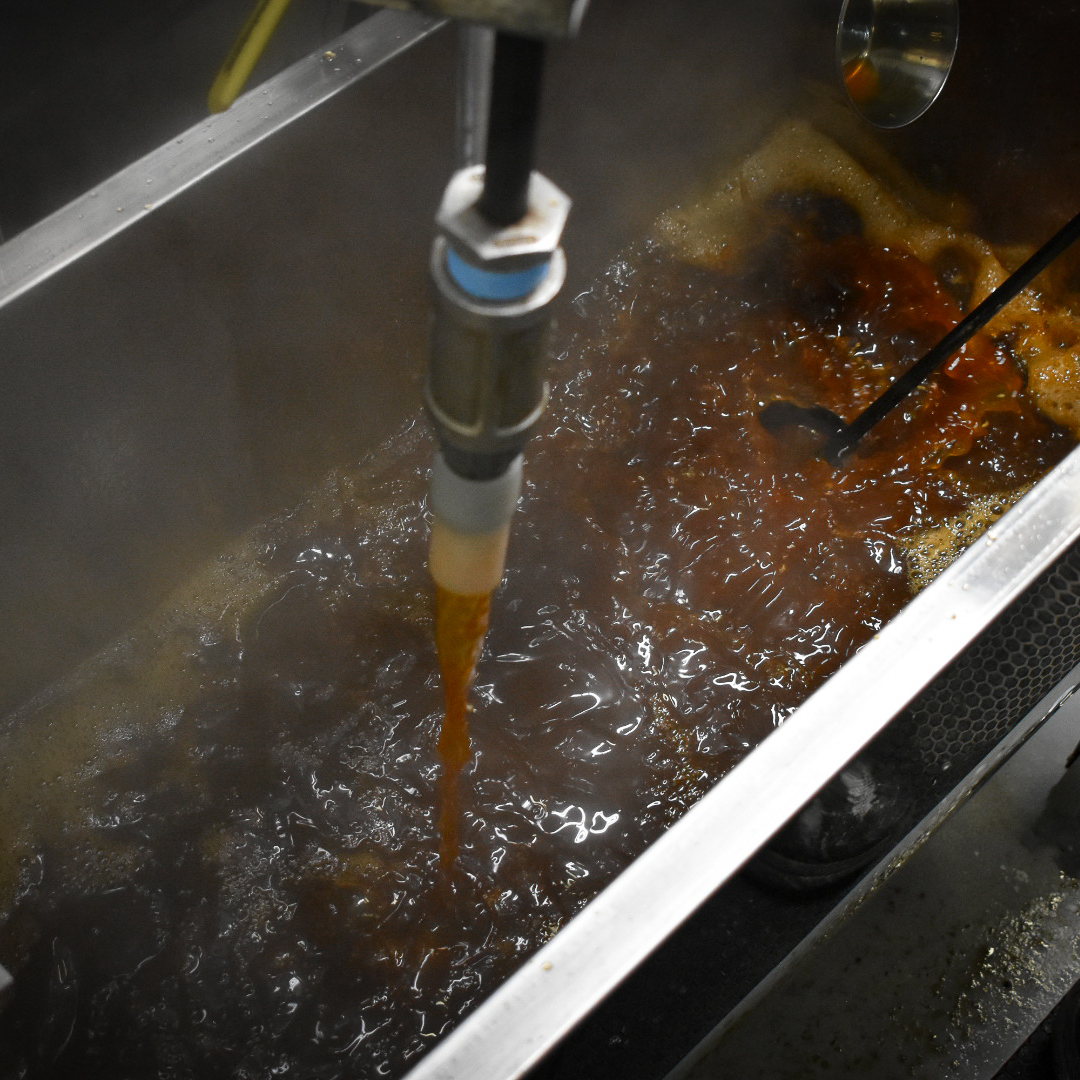 Boiling Maple Syrup in Stainless Steel Finishing Pan – Graves Maple Products
Rich, amber-colored maple syrup boils vigorously in a stainless steel finishing pan at Graves Maple Products, with steam rising and a valve dispensing syrup into the bubbling mixture.