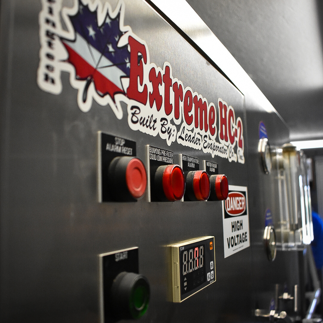 Extreme HC-2 Maple Syrup Processing Control Panel – Graves Maple Products
Close-up of the Extreme HC-2 control panel, built by Leader Evaporator Co., with warning labels, buttons, and digital display used in the maple syrup processing system at Graves Maple Products.